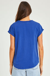 Model Elhana wearing size 10 of the Elements Manly Cotton Tee in colour Tranblue (Blue), from the back