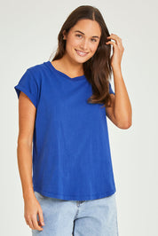 Model Elhana wearing size 10 of the Elements Manly Cotton Tee in colour Tranblue (Blue), from the front, cropped image