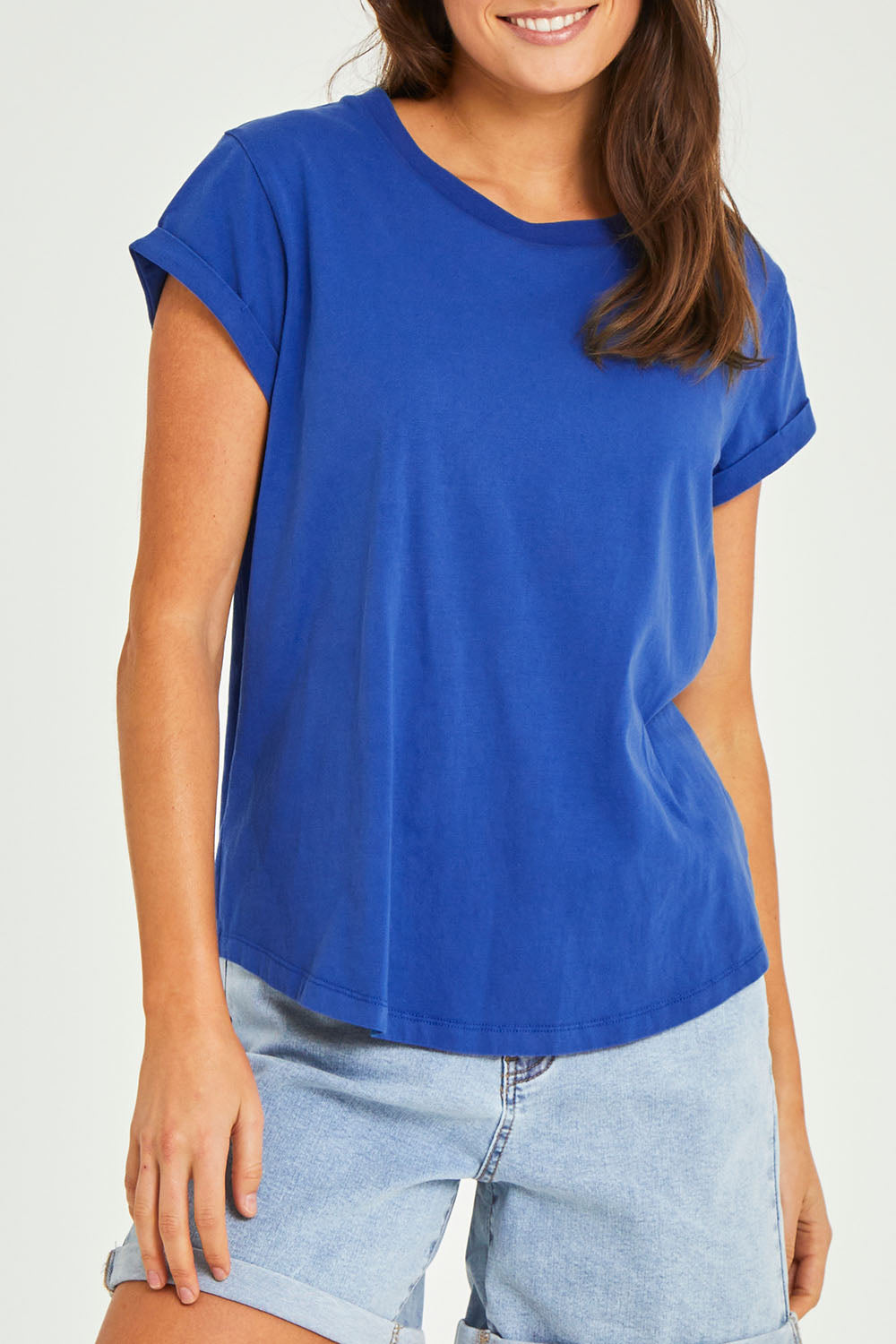 Model Elhana wearing size 10 of the Elements Manly Cotton Tee in colour Tranblue (Blue), from the front, cropped image