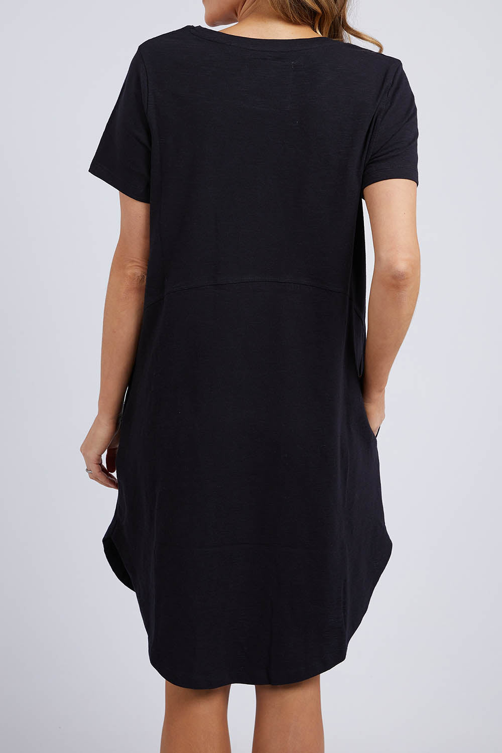 A model wearing the Elements Bay Cotton Dress in colour Black (Black), from the back