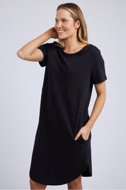 A model wearing the Elements Bay Cotton Dress in colour Black (Black), from the front, cropped image