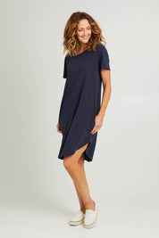 Model Emma wearing size 10 of the Elements Bay Cotton Dress in colour Sapphire (Blue), from the front, showing the whole outfit