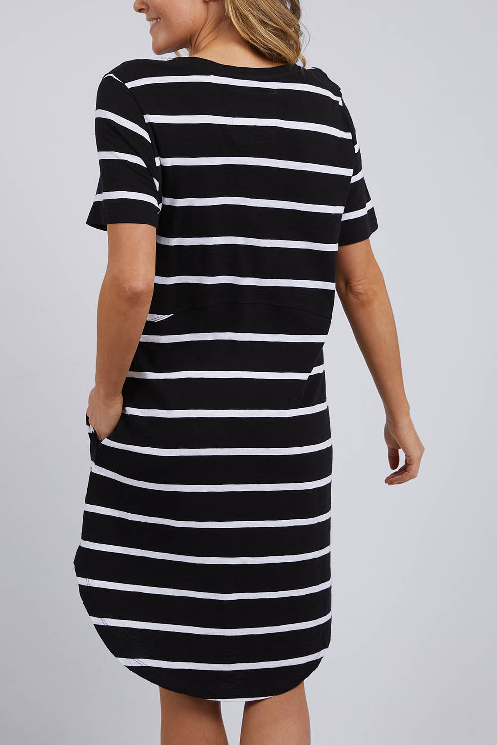 A model wearing the Elements Bay Stripe Dress in colour Blackwhite (Black), from the back