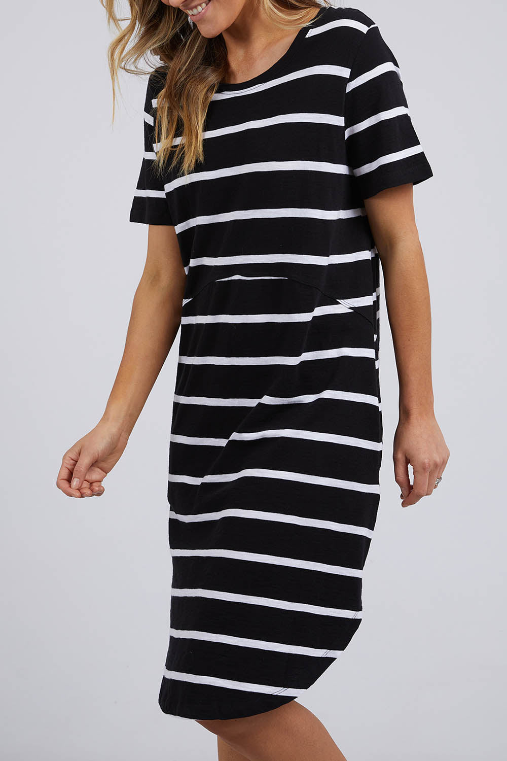 A model wearing the Elements Bay Stripe Dress in colour Blackwhite (Black), from the front, cropped image
