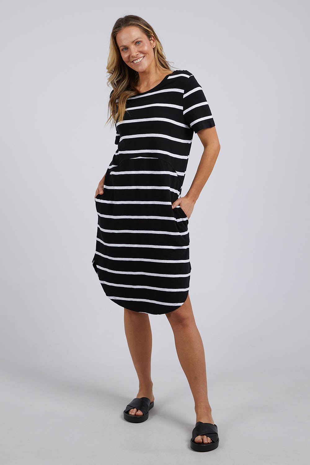 A model wearing the Elements Bay Stripe Dress in colour Blackwhite (Black), from the front, showing the whole outfit