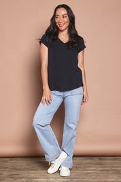 Model Katie wearing size 8 of the Elements Manly Cotton Vee Tee in colour Black (Black), from the front, showing the whole outfit
