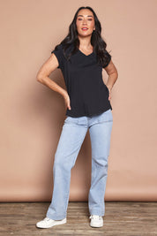 Model Katie wearing size 8 of the Elements Manly Cotton Vee Tee in colour Black (Black), from the front, showing the whole outfit
