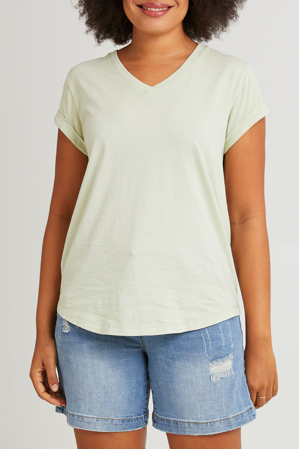 Model Olivia wearing size 10 of the Elements Manly Cotton Vee Tee in colour Foggreen (Green), from the front, cropped image