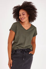Model Olivia wearing size 10 of the Elements Manly Cotton Vee Tee in colour Khaki (Green), from the front, cropped image