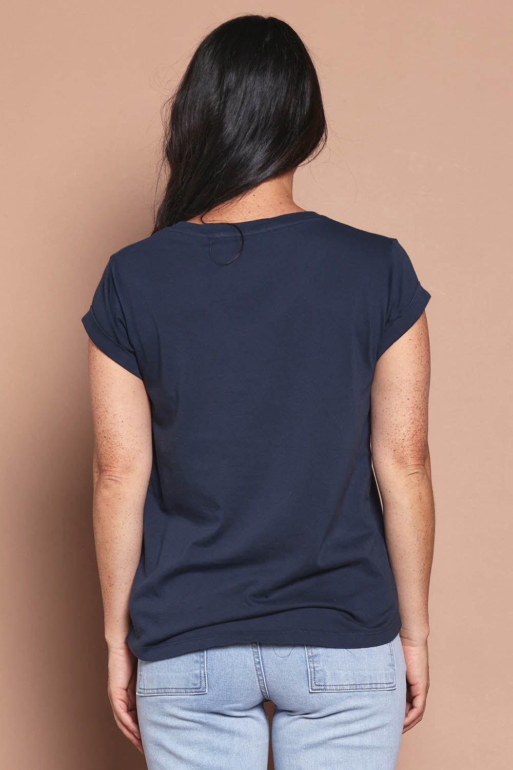Model Katie wearing size 8 of the Elements Manly Cotton Vee Tee in colour Navy (Blue), from the back