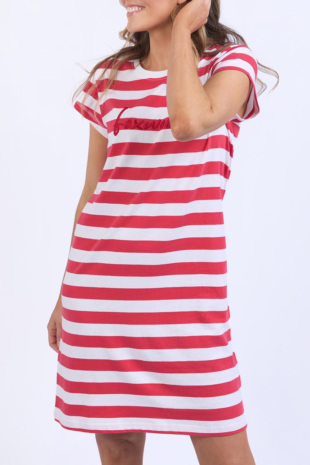 A model wearing the Elements Signature Tee Dress in colour Cayennewhi (Red), from the front, cropped image