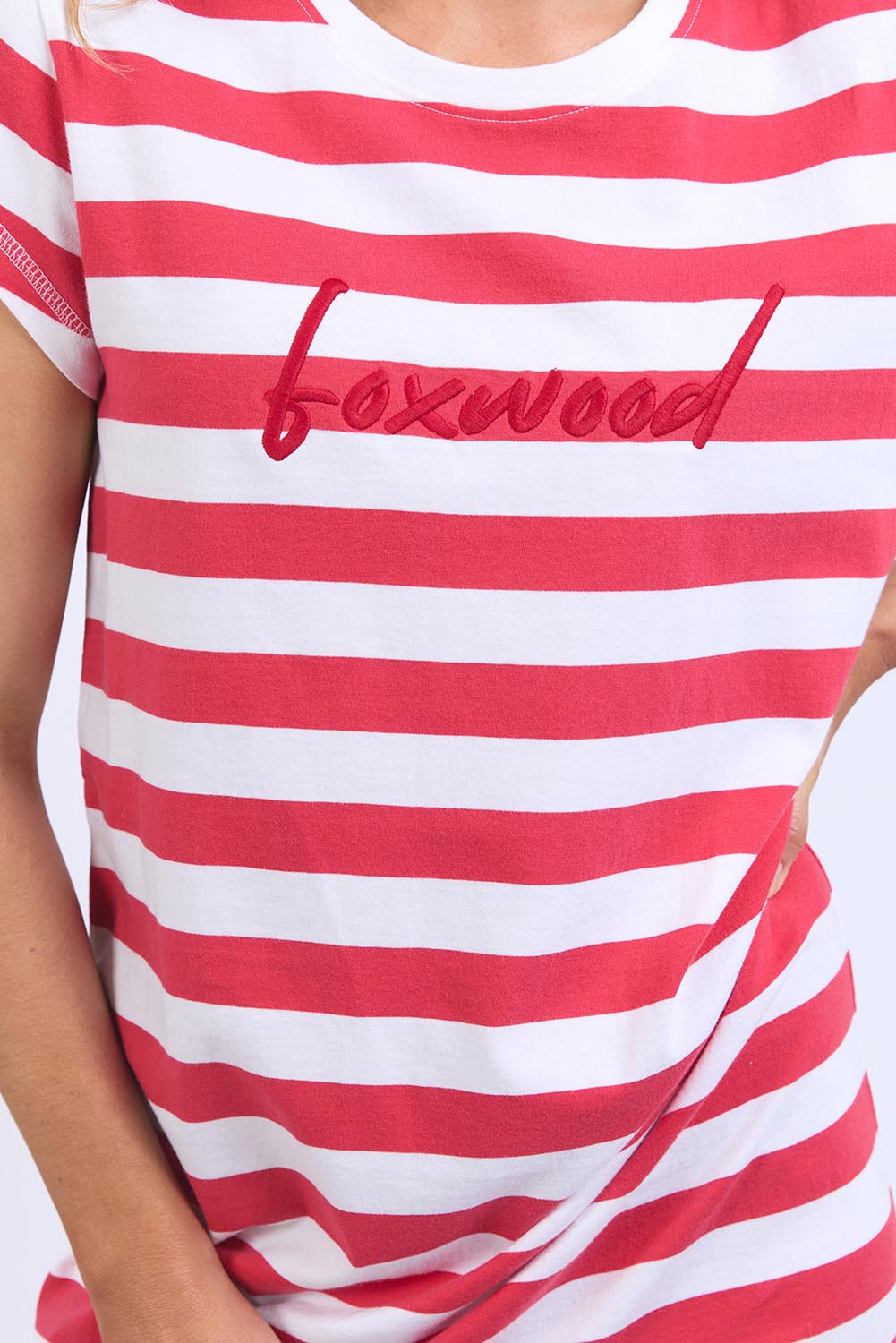 A model wearing the Elements Signature Tee Dress in colour Cayennewhi (Red), from the front, cropped image