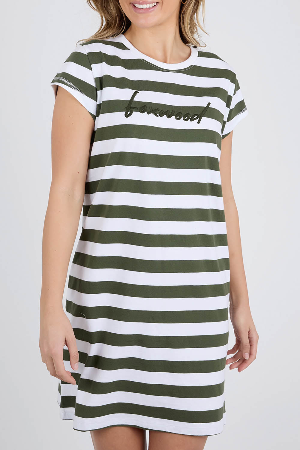 A model wearing the Elements Signature Tee Dress in colour Khakiwhite (Green), from the front, cropped image