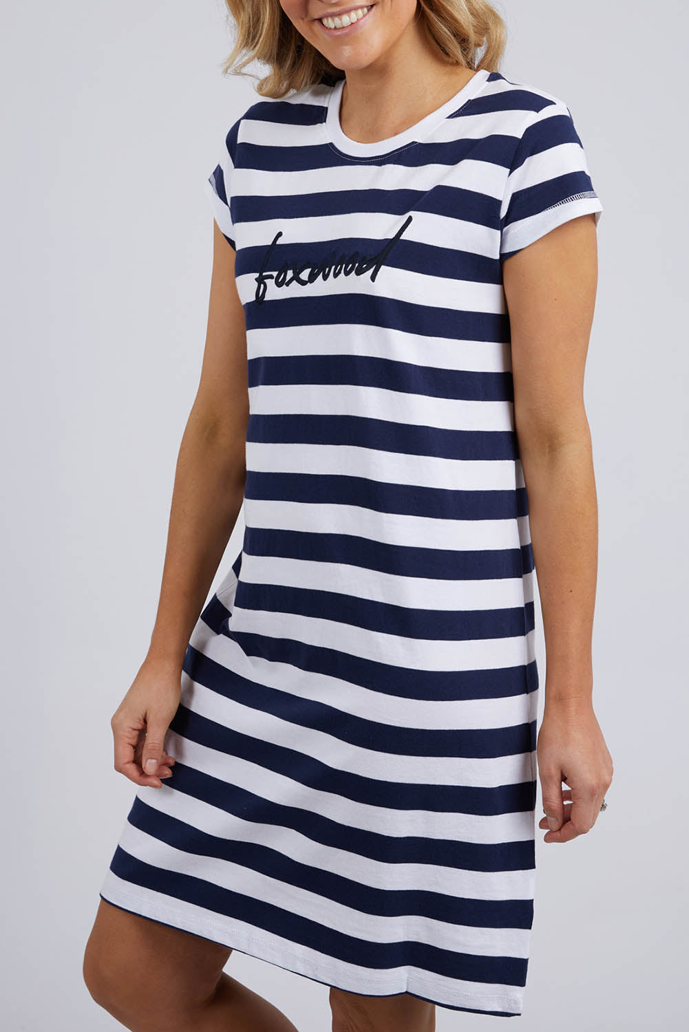 A model wearing the Elements Signature Tee Dress in colour Sapstripe (Blue), from the front, cropped image