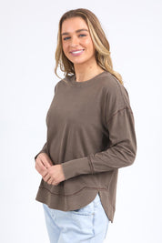 A model wearing the Elements Farrah Cotton Long Sleeve in colour Coffee, from the front, cropped image