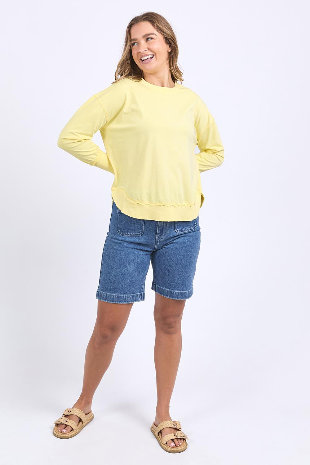 A model wearing the Elements Farrah Cotton Long Sleeve in colour Lemon, from the front, showing the whole outfit