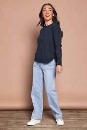 Model Katie wearing size 8 of the Elements Farrah Cotton Long Sleeve in colour Navy (Blue), from the front, showing the whole outfit