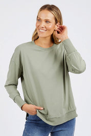 A model wearing the Elements Farrah Cotton Long Sleeve in colour Sagegreen (Green), from the front, cropped image