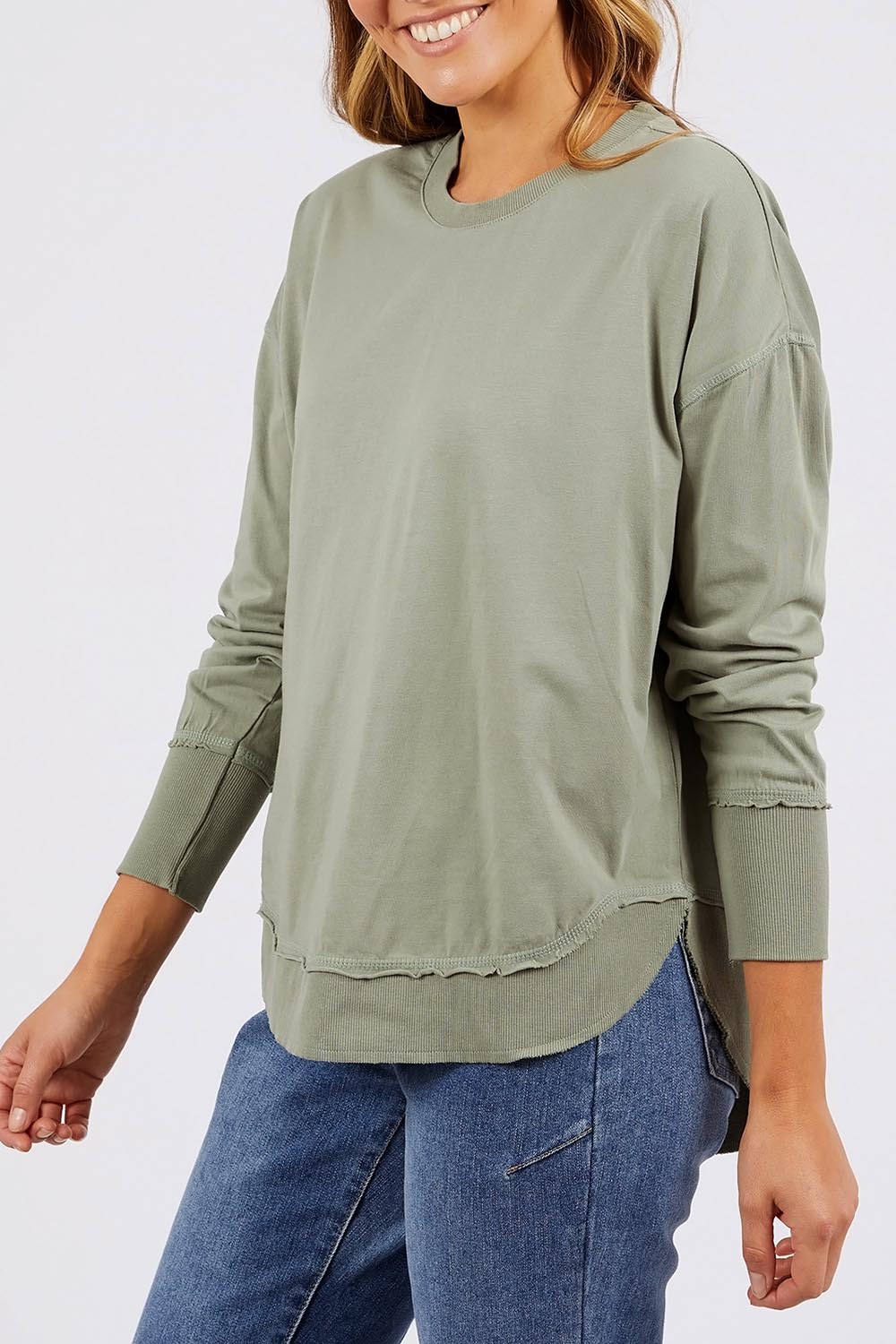 A model wearing the Elements Farrah Cotton Long Sleeve in colour Sagegreen (Green), from the front, cropped image