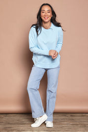 Model Katie wearing size 8 of the Elements Farrah Cotton Long Sleeve in colour Waterfall (Blue), from the front, showing the whole outfit