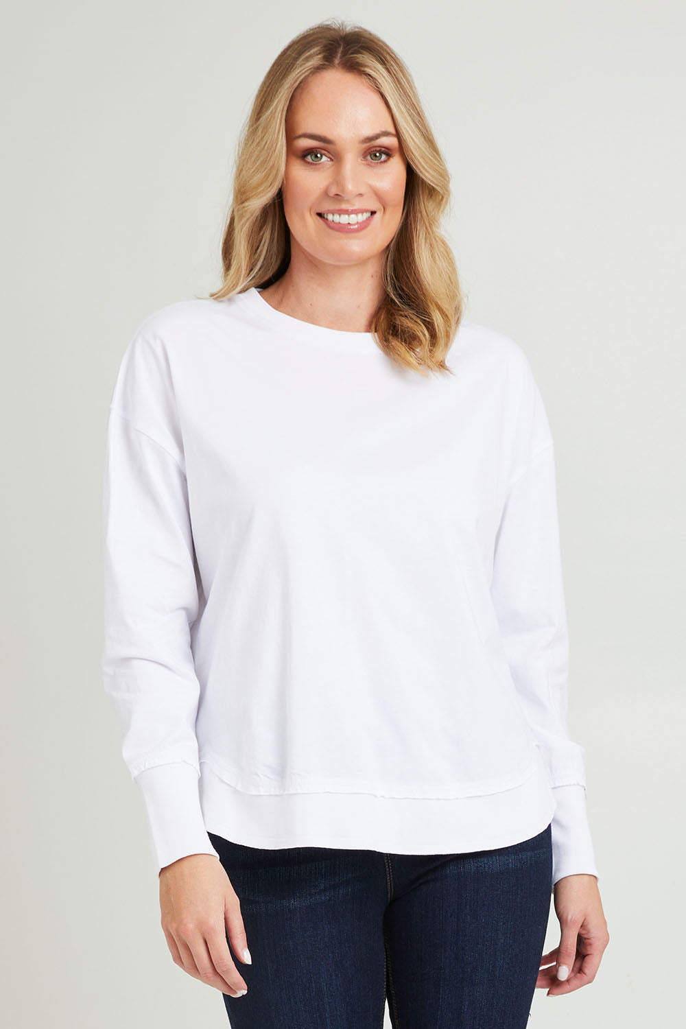 Model Grace wearing size 10 of the Elements Farrah Cotton Long Sleeve in colour White (White), from the front, cropped image