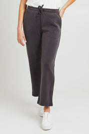 Model Grace wearing size 10 of the Elements Storm Pant in colour Stormblack (Black), from the front, cropped image