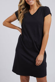 A model wearing the Elements Manly Vee Tee Dress in colour Black (Black), from the front, cropped image