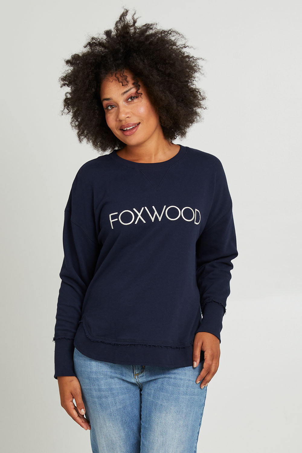 Model Olivia wearing size 10 of the Elements Simplified Metallic Cotton Crew in colour Navy (Blue), from the front, cropped image