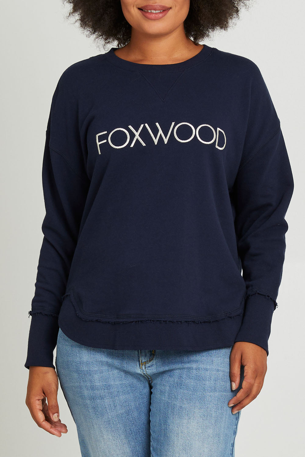 Model Olivia wearing size 10 of the Elements Simplified Metallic Cotton Crew in colour Navy (Blue), from the front, cropped image