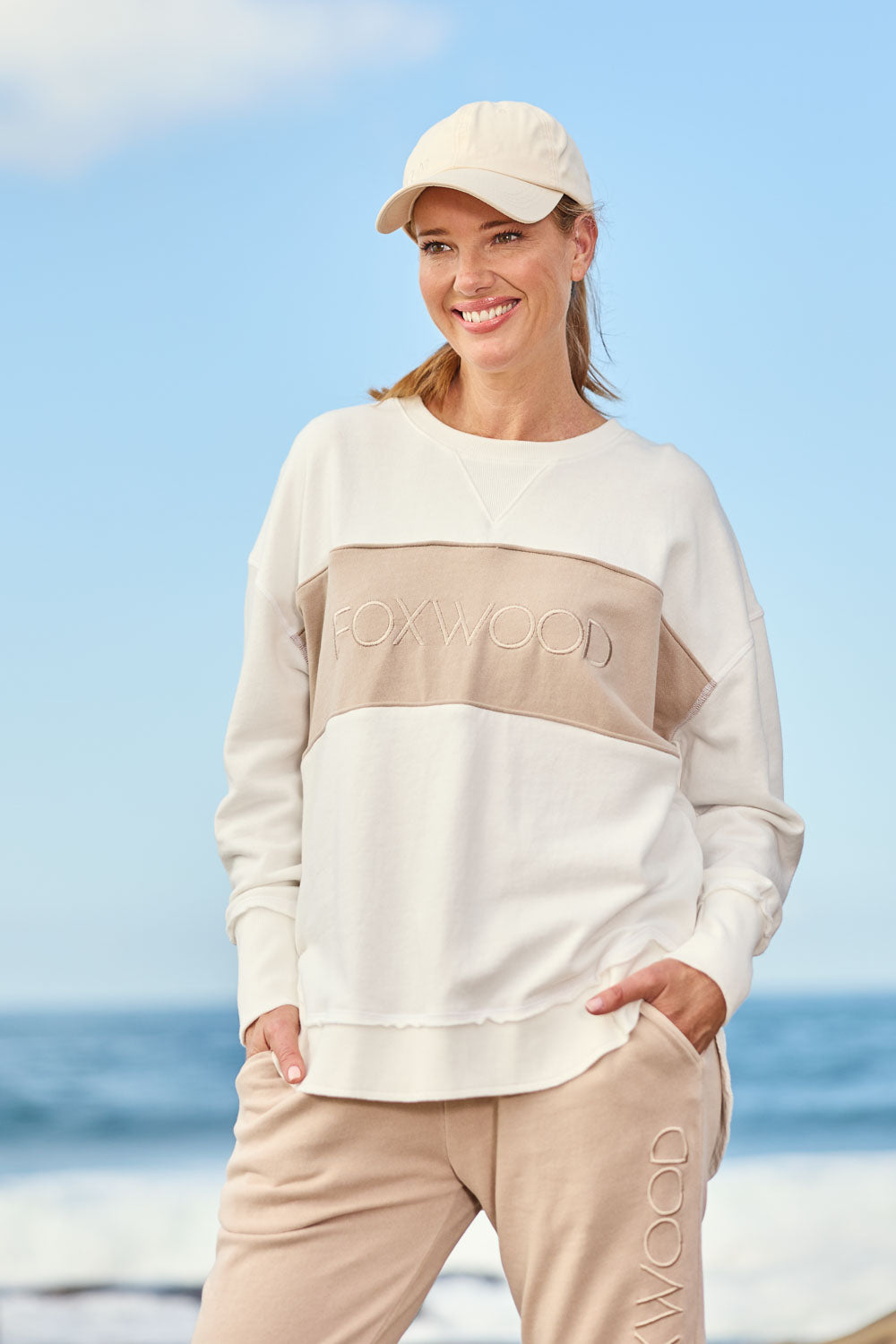 A model wearing the Leisure Simplified Tonal Crew in colour Vinwhite (White), from the front, showing the whole outfit
