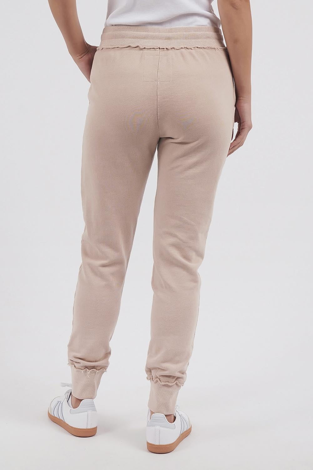 A model wearing the Leisure Simplified Pants in colour Oatmeal, from the back