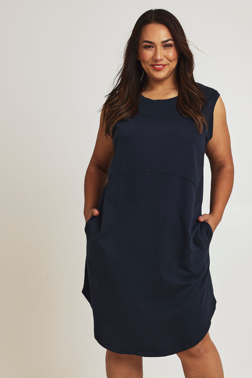 Model Ashleigh wearing size 16 of the Elements Bungalow Dress in colour Dksapphire (Blue), from the front, cropped image