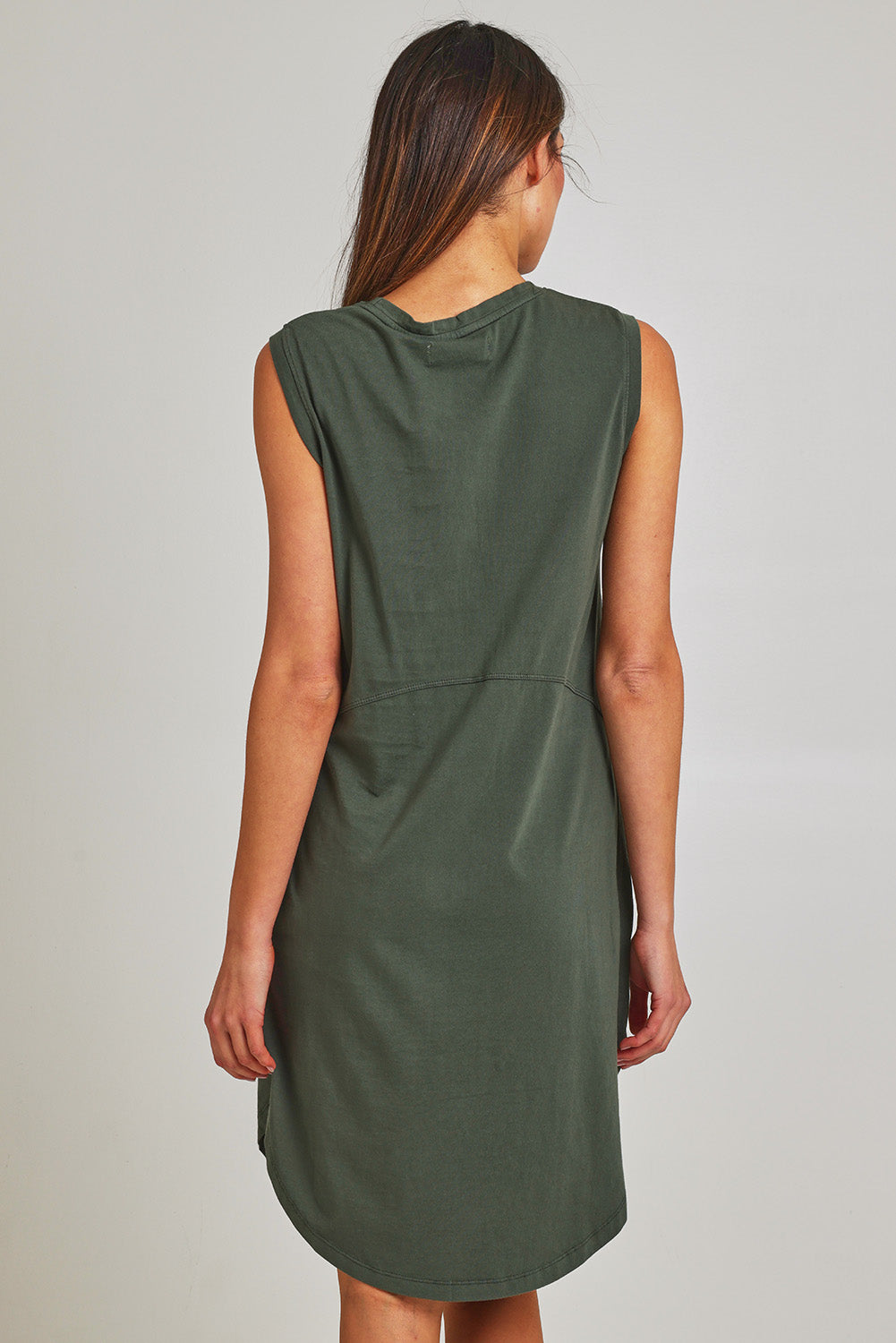 Model Madeline wearing size 10 of the Elements Bungalow Dress in colour Khaki (Green), from the back