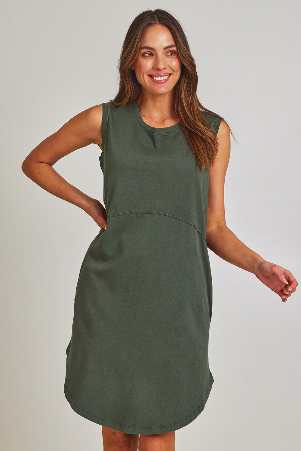 Model Madeline wearing size 10 of the Elements Bungalow Dress in colour Khaki (Green), from the front, cropped image
