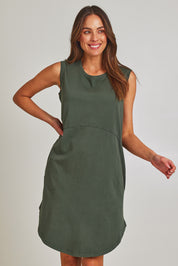 Model Madeline wearing size 10 of the Elements Bungalow Dress in colour Khaki (Green), from the front, cropped image