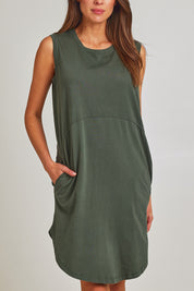 Model Madeline wearing size 10 of the Elements Bungalow Dress in colour Khaki (Green), from the front, cropped image