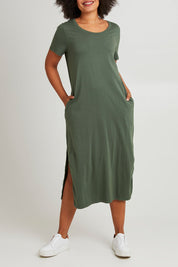 Model Olivia wearing size 10 of the Elements Rhythm Dress in colour Khaki (Green), from the front, cropped image