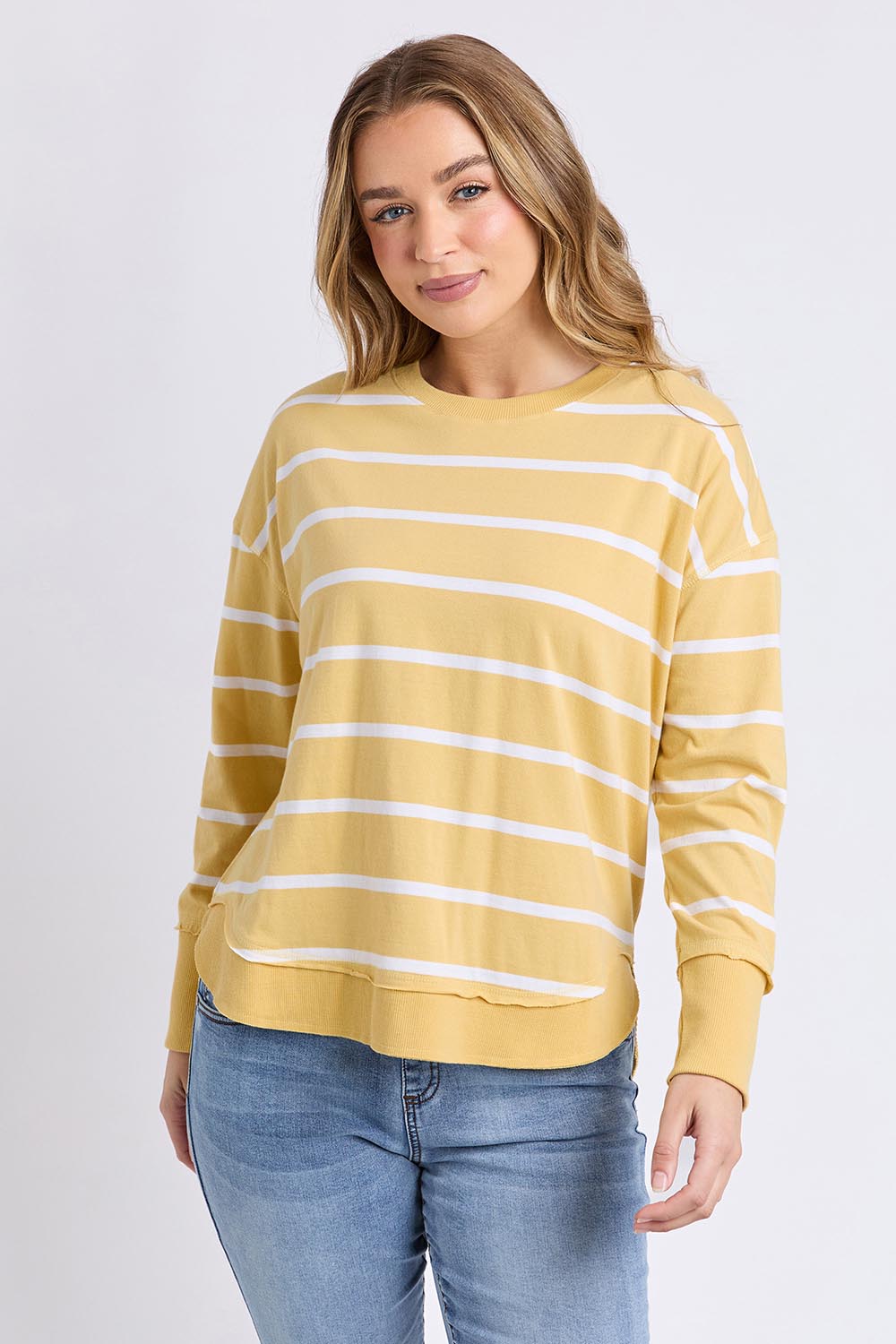 A model wearing the Elements Farrah Stripe Cotton Long Sleeve in colour Butterwhit, from the front, cropped image