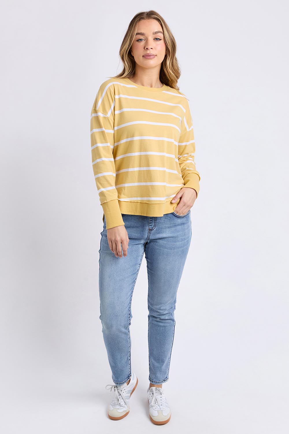 A model wearing the Elements Farrah Stripe Cotton Long Sleeve in colour Butterwhit, from the front, showing the whole outfit