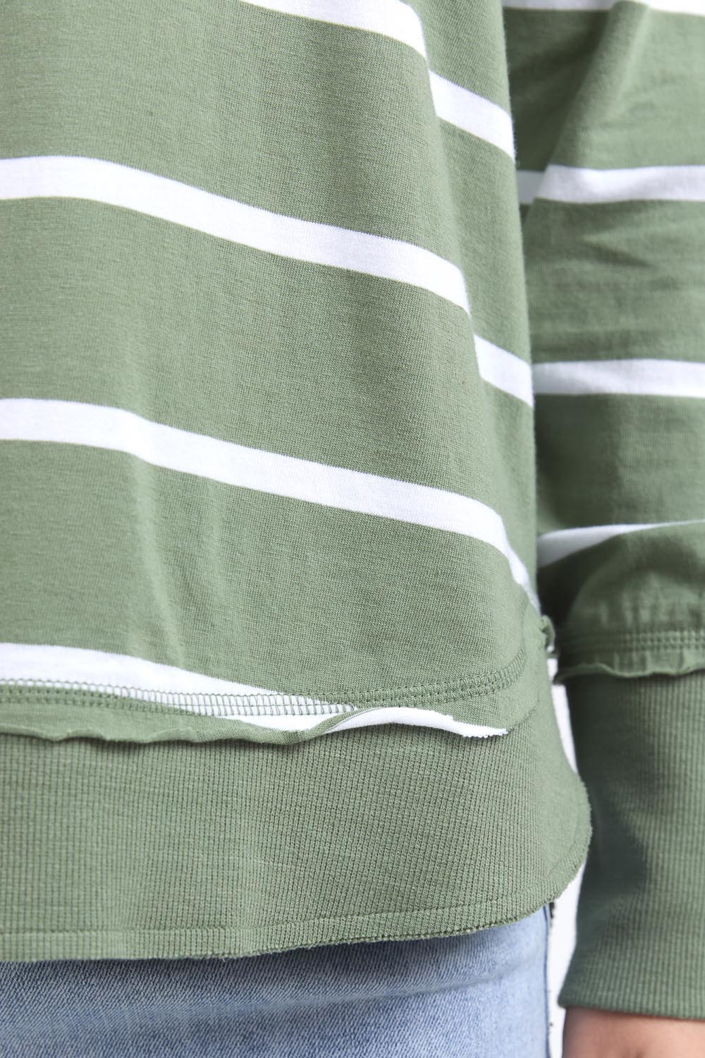 A model wearing the Elements Farrah Stripe Cotton Long Sleeve in colour Sagewhite (Green), from the front, cropped image