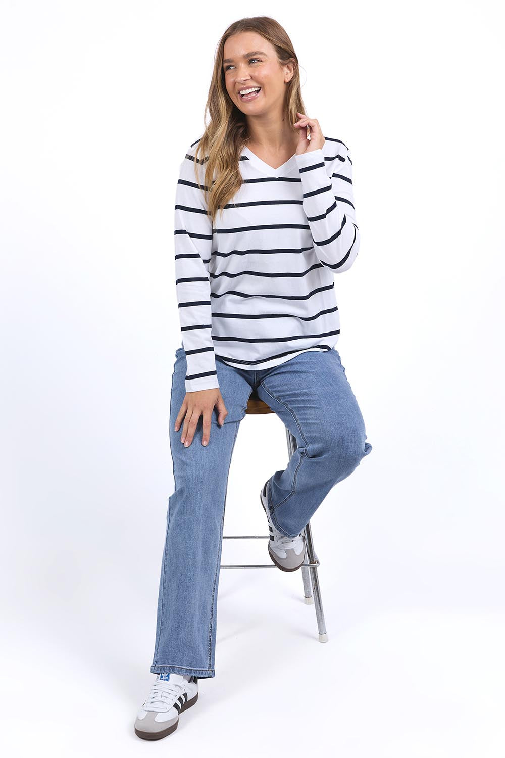A model wearing the Elements Manly Vee Stripe Cotton Long Sleeve in colour Whitenavy (White), from the front, showing the whole outfit