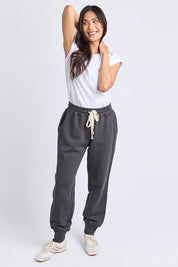 A model wearing the Elements Cotton College Track Pant in colour Coal (Grey), from the front, showing the whole outfit