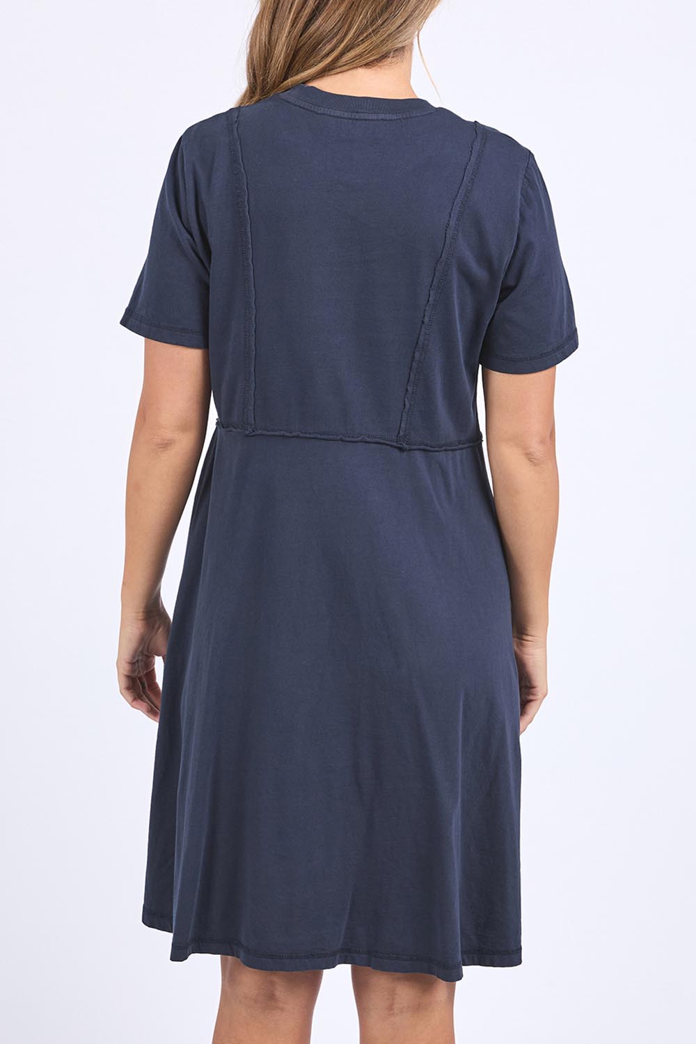 A model wearing the Elements Eva Cotton Dress in colour Navy (Blue), from the back