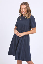 A model wearing the Elements Eva Cotton Dress in colour Navy (Blue), from the front, cropped image