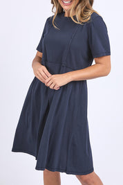 A model wearing the Elements Eva Cotton Dress in colour Navy (Blue), from the front, cropped image