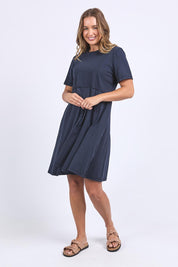 A model wearing the Elements Eva Cotton Dress in colour Navy (Blue), from the front, showing the whole outfit
