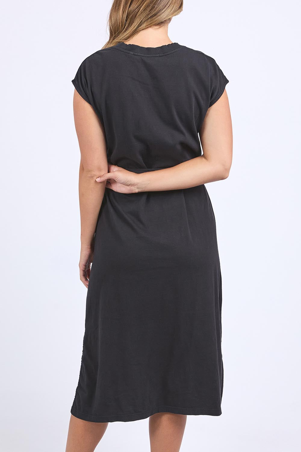 A model wearing the Elements Casey Cotton Dress in colour Black (Black), from the back