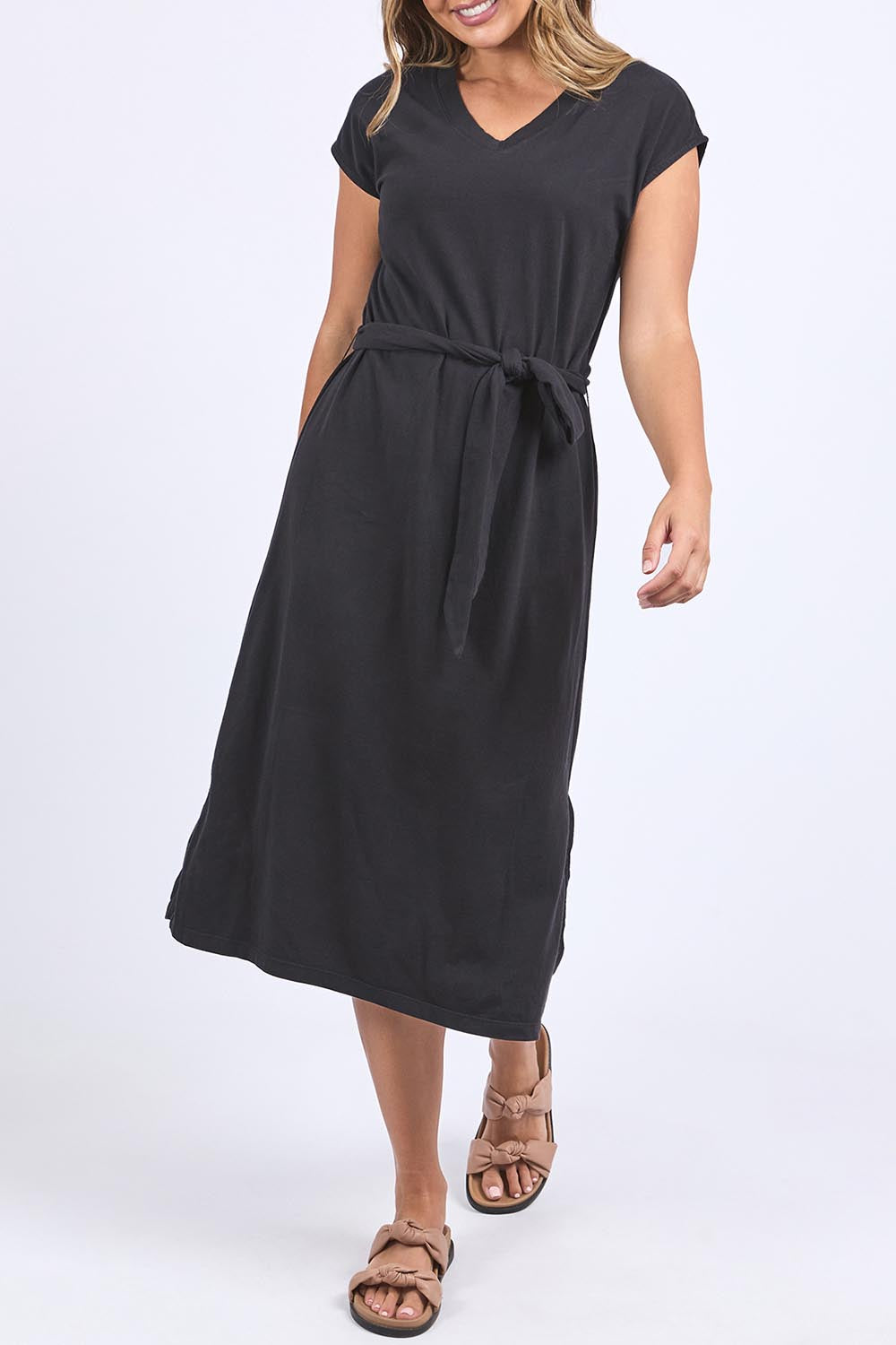 A model wearing the Elements Casey Cotton Dress in colour Black (Black), from the front, cropped image