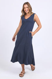 A model wearing the Elements Aspen Cotton Dress in colour Navy (Blue), from the front, showing the whole outfit