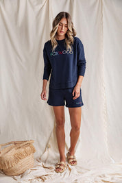 A model wearing the Elements Simplified Confetti Cotton Crew in colour Navy (Blue), from the front, showing the whole outfit